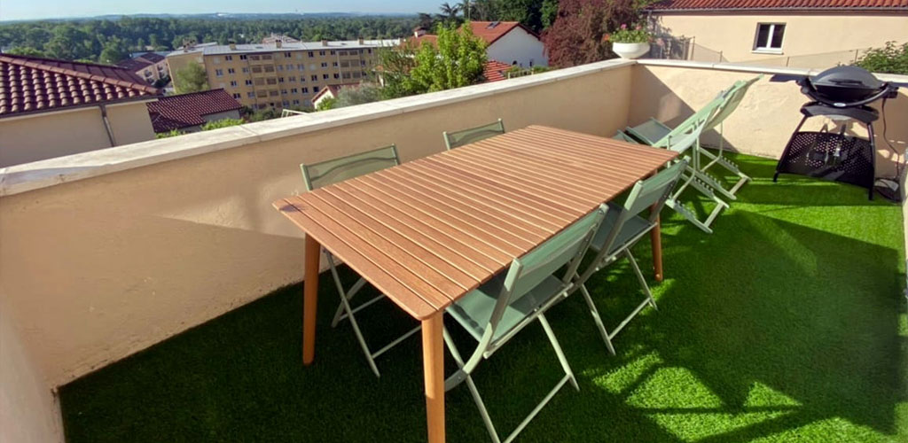 Sunny balcony with artificial grass